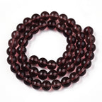 Coconut brown transparent glass round beads, 8mm, on a strand - close-up